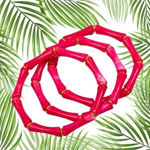 Three hot pink faux, bamboo stacking bracelets with gold accents. Tiki p…